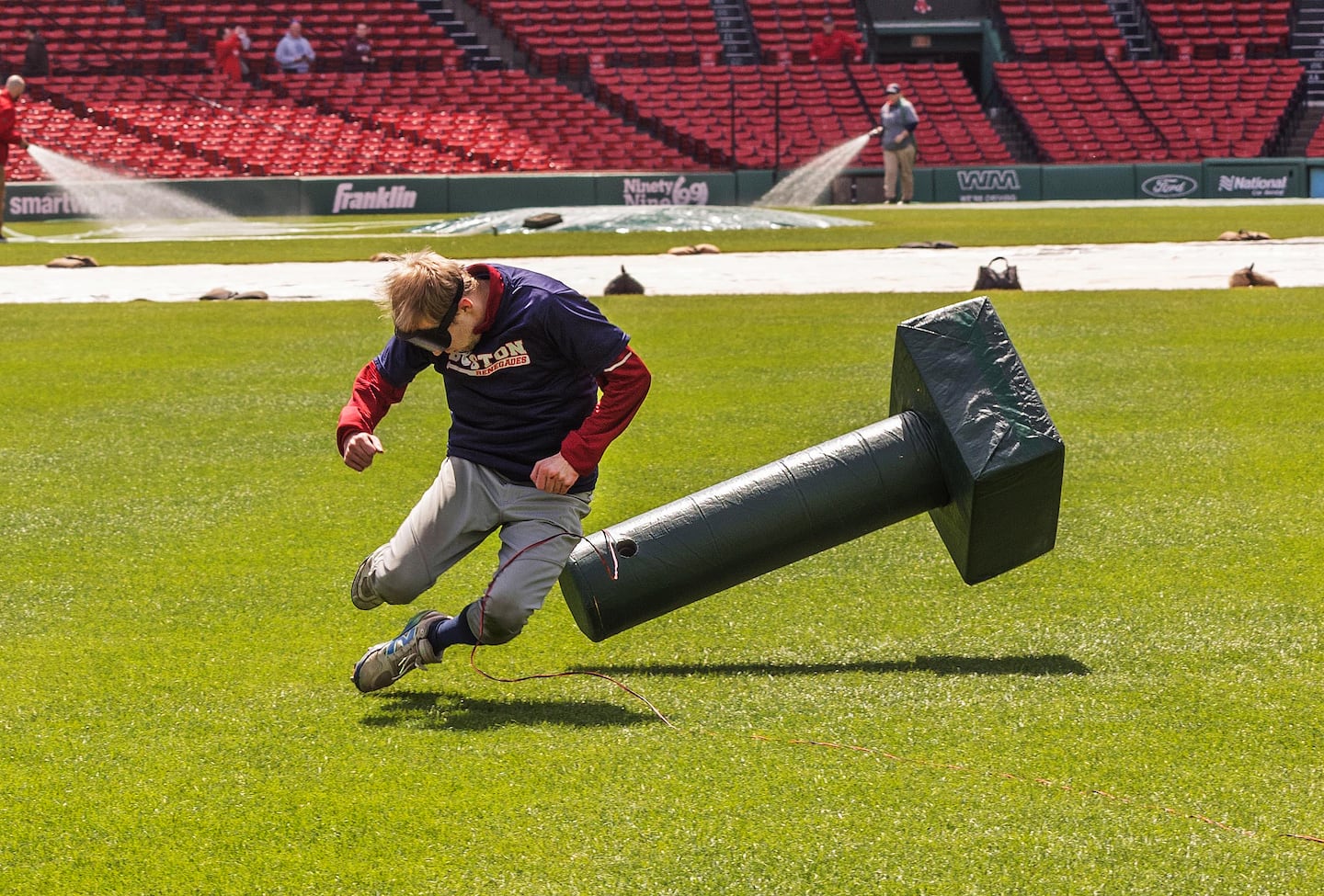 An image taken by Tina J.C. Caruso shows Boston Renegades' Chris Kimball levitating and falling into a sonic base at Fenway Park.
