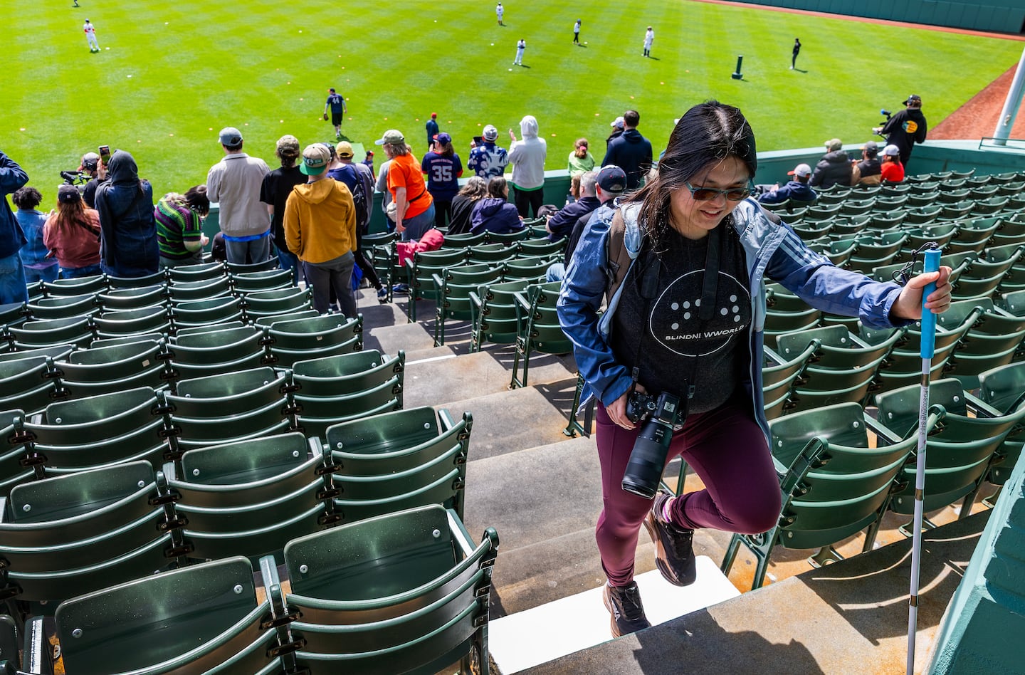 Caruso walks up the steps of the bleachers at Fenway Park.