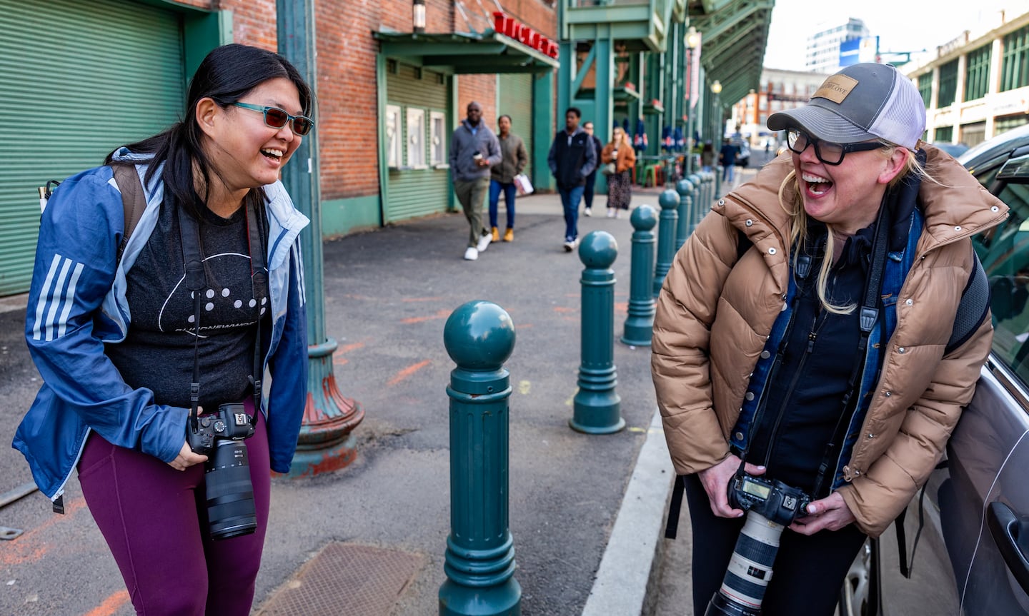 Caruso and one of her mentors, celebrity photographer Kelly Brett, laugh it off on Lansdowne Street.