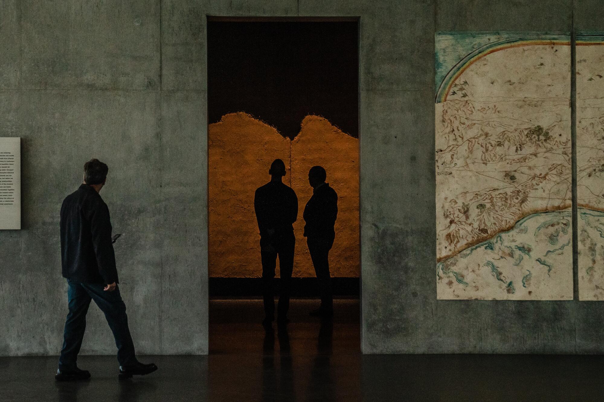 People wander inside the concrete museum.