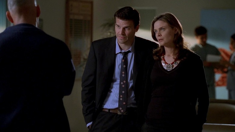 Bones and Booth talking to a man in a suit at Bones
