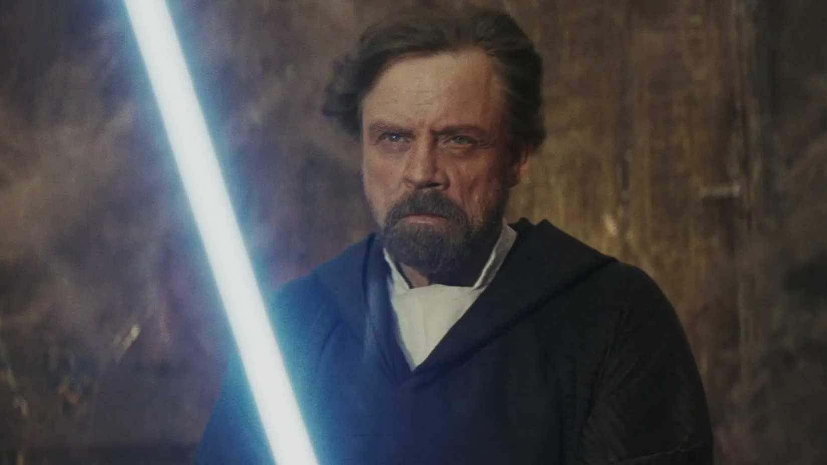 Luke holding a lightsaber in The Last Jedi