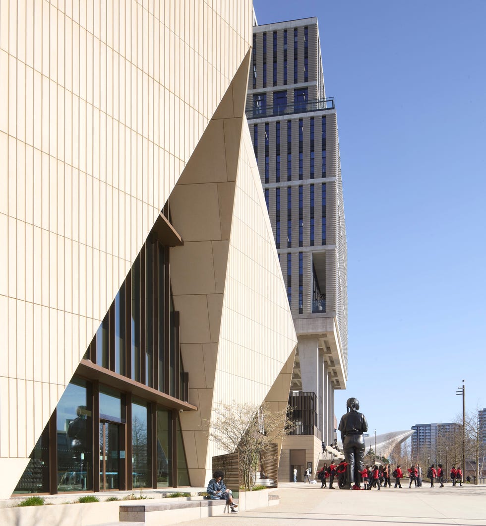 Modern architecture with people sitting on benches.
